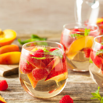 Homemade Sparkling White Wine Sangria with Peaches and Raspberries