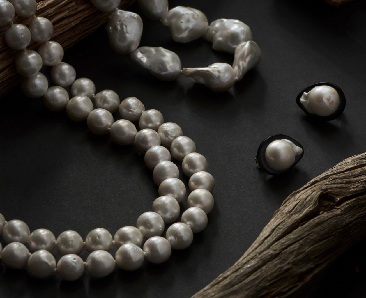 variety of pearl jewelry on table
