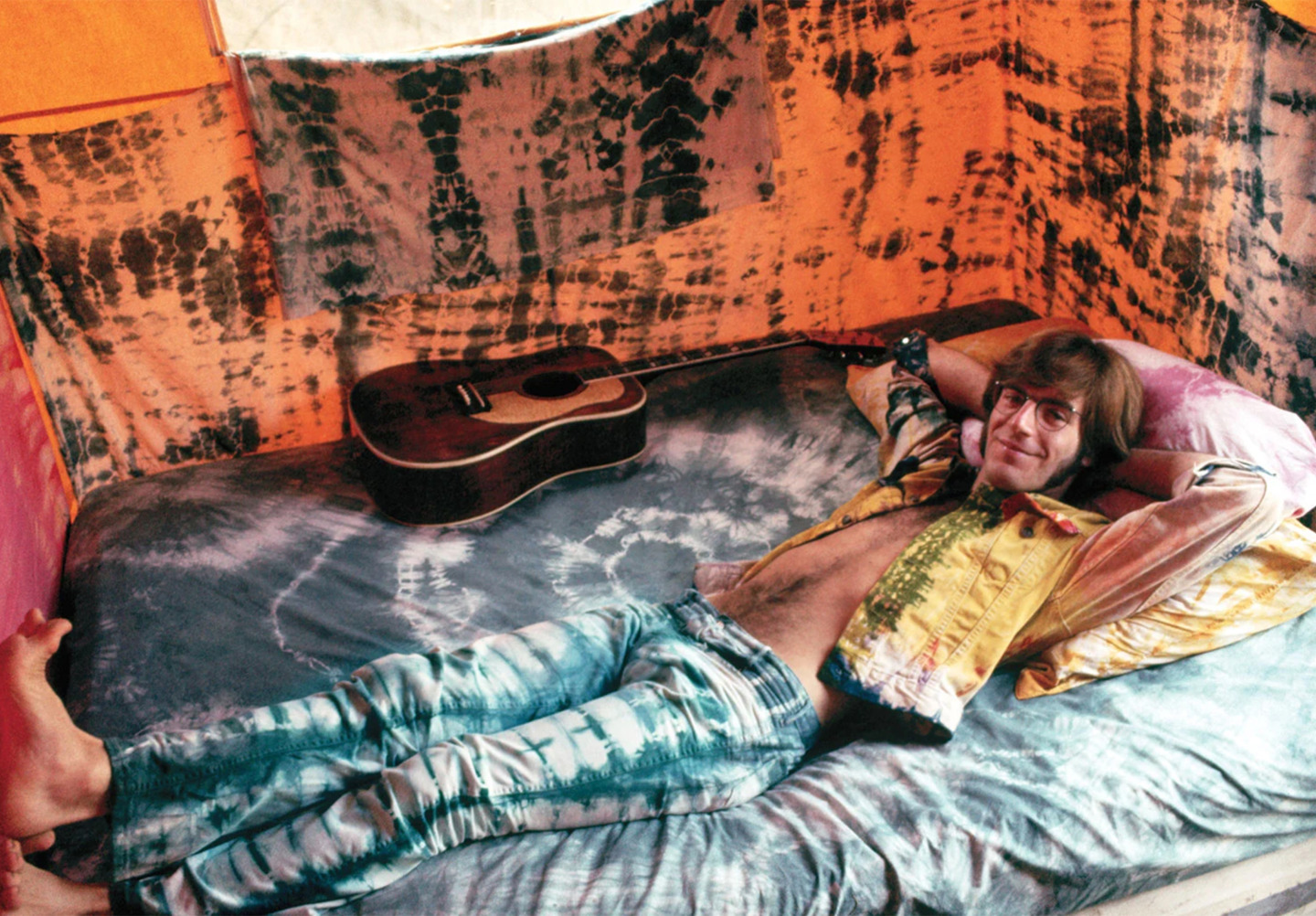 Musician John Sebastain Wearing Tie-Dye and Lying Down in Tie-Dye Painted Tent