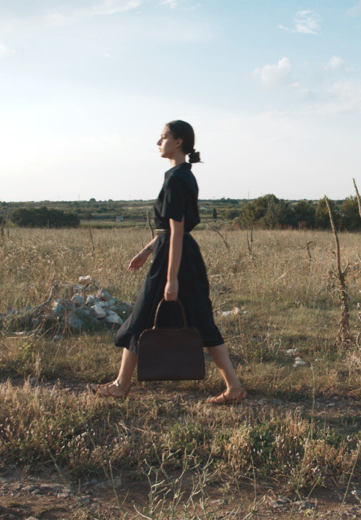 Woman Walking with Corîu Italian Leather Handbag
