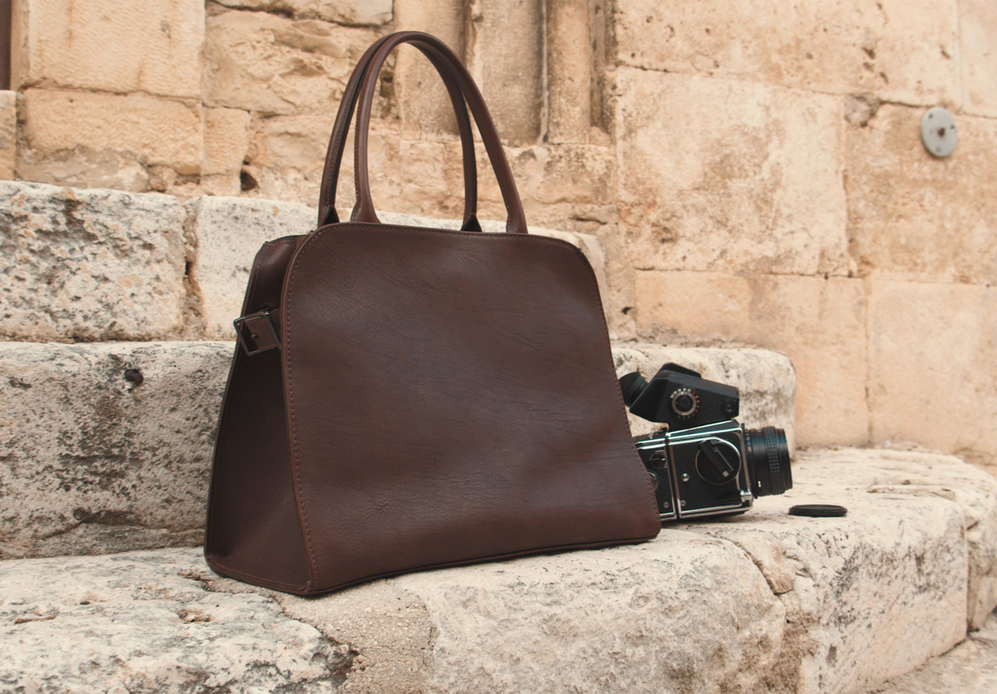 Corîu Italian Leather Handbag posed with Medium Format Film Camera on Steps